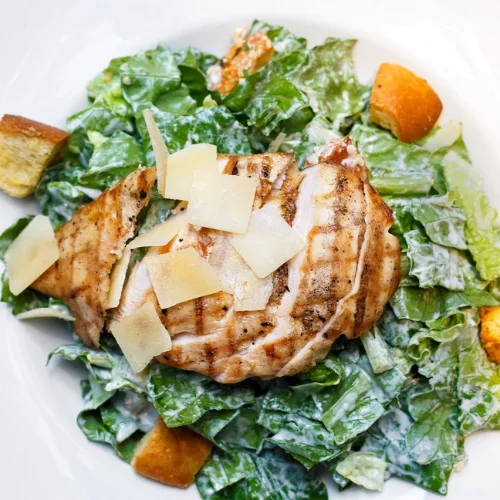 Grilled Chicken Caesar Salad - Fresh romaine lettuce with grilled chicken and Caesar dressing