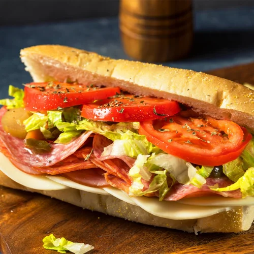 Italian Sub - Piled high with premium Italian meats, fresh lettuce, tomatoes, onions, and our house dressing on a freshly baked sub roll.