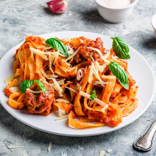 Pasta with Meatballs - Classic pasta topped with homemade meatballs and sauce